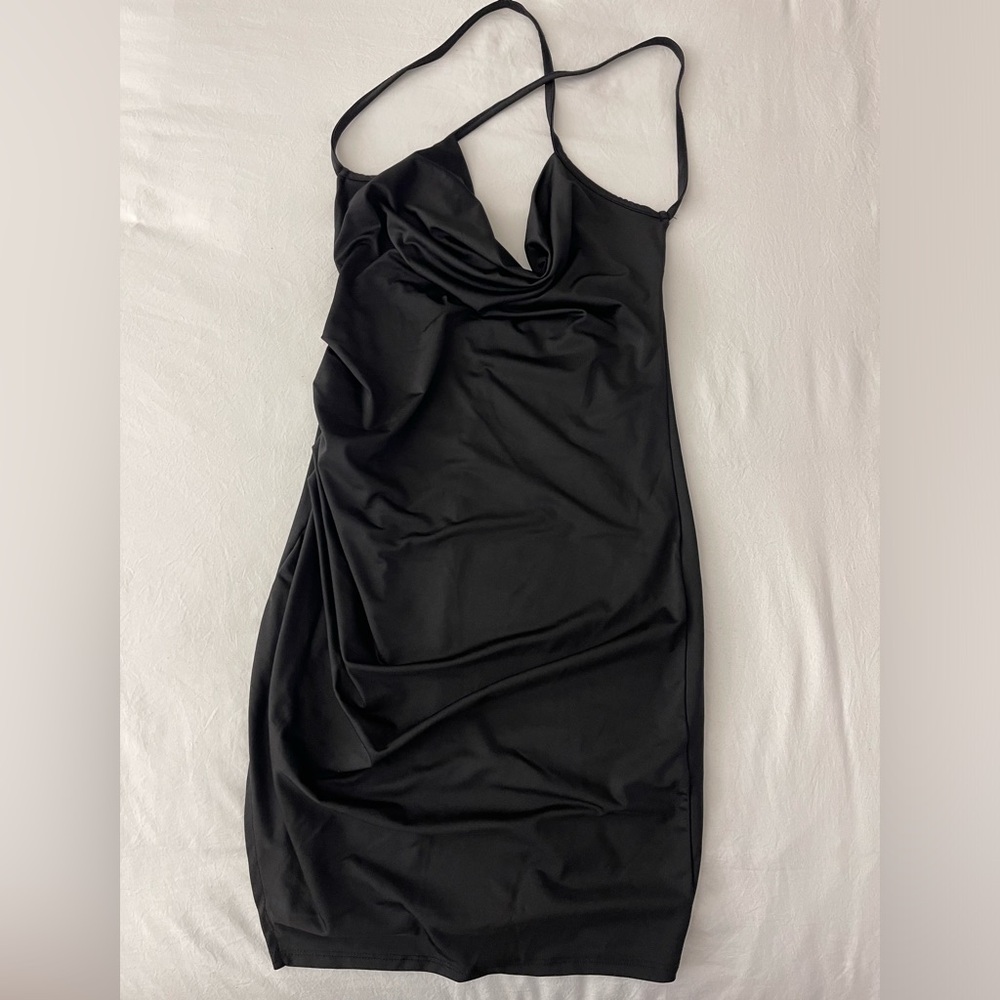 Black slinky dress with cross straps and slit on the side